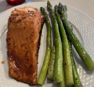Baked teriyaki salmon and asparagus on a dinner plate